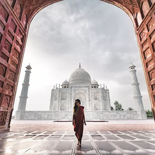 Scenic view of a person walking in front of the Taj Mahal in Agra, India