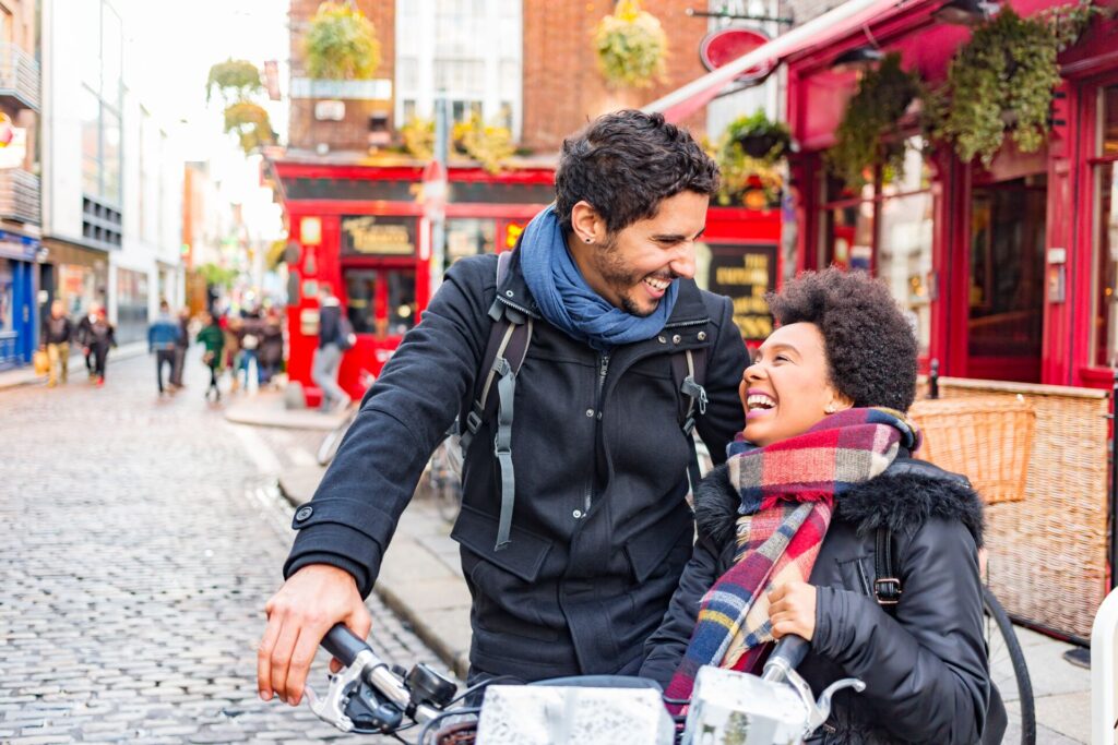 couple laughing while on the streets of a. city in ireland