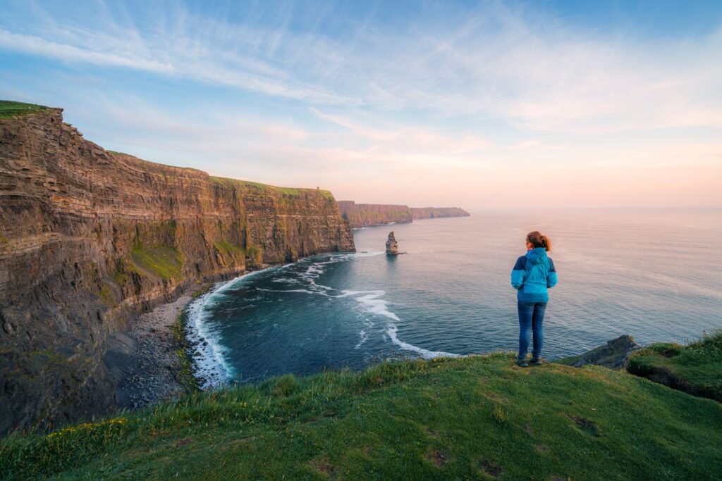 woman looking out over the cliffs of Ireland