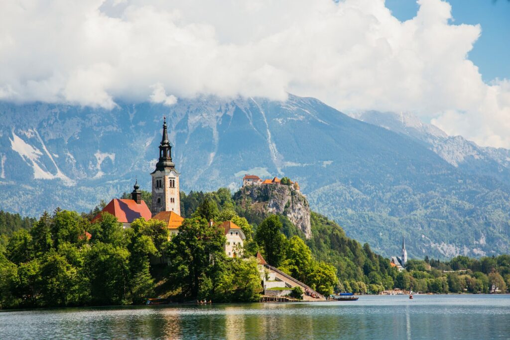 A tower on a hill on a lake in Slovenia.