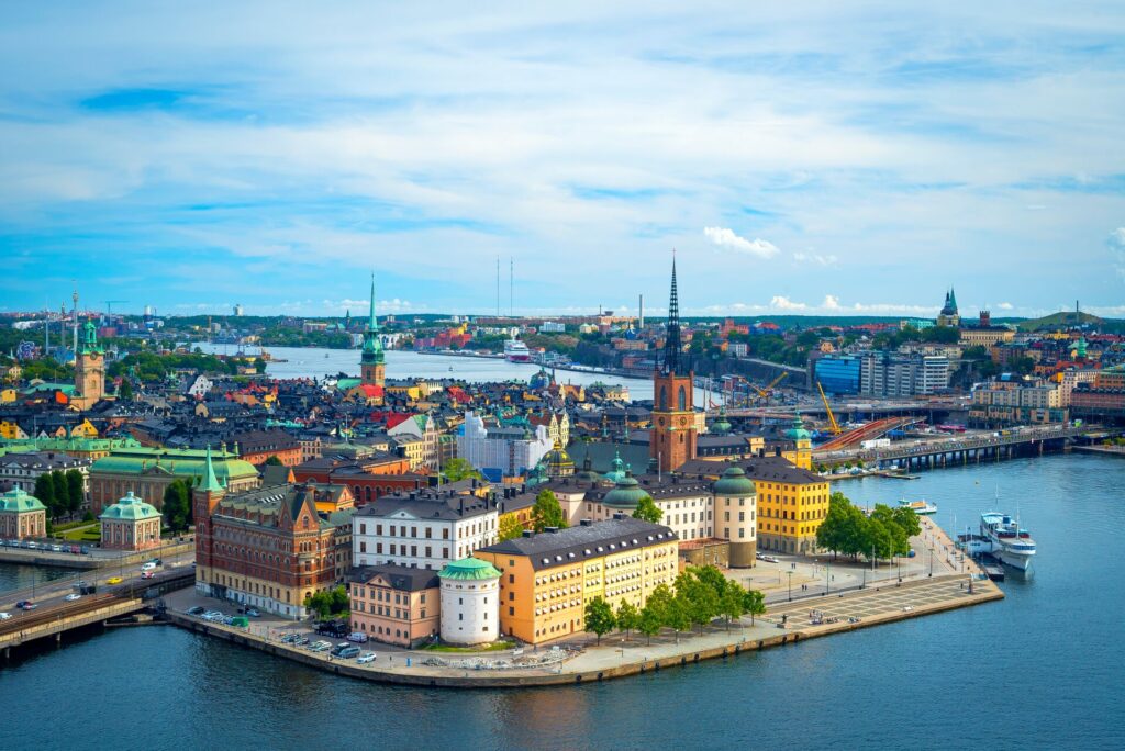 Aerial shot of Stickholm in Swedens, showing colourful buildings alongside a large lake.