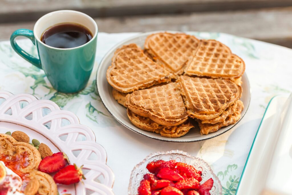 Heart-shaped Norwegian waffles with coffee and fruit