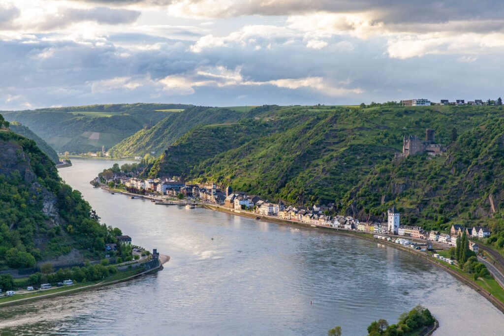 The Rhine River snakes through a deep valley lined with towns and greenery