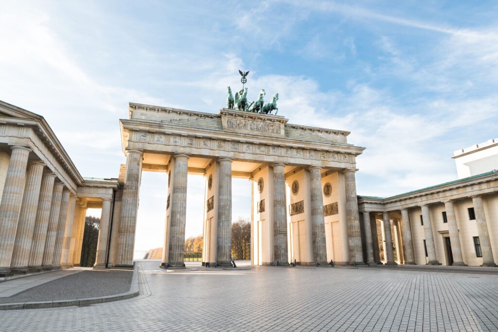 Brandenburg Gate in Germany with blue sky behind.