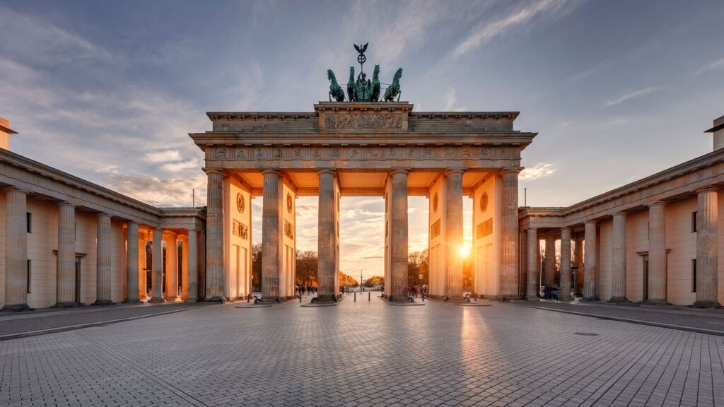 Sun sets through Brandenburgh Gate, a famous landmark in Germany