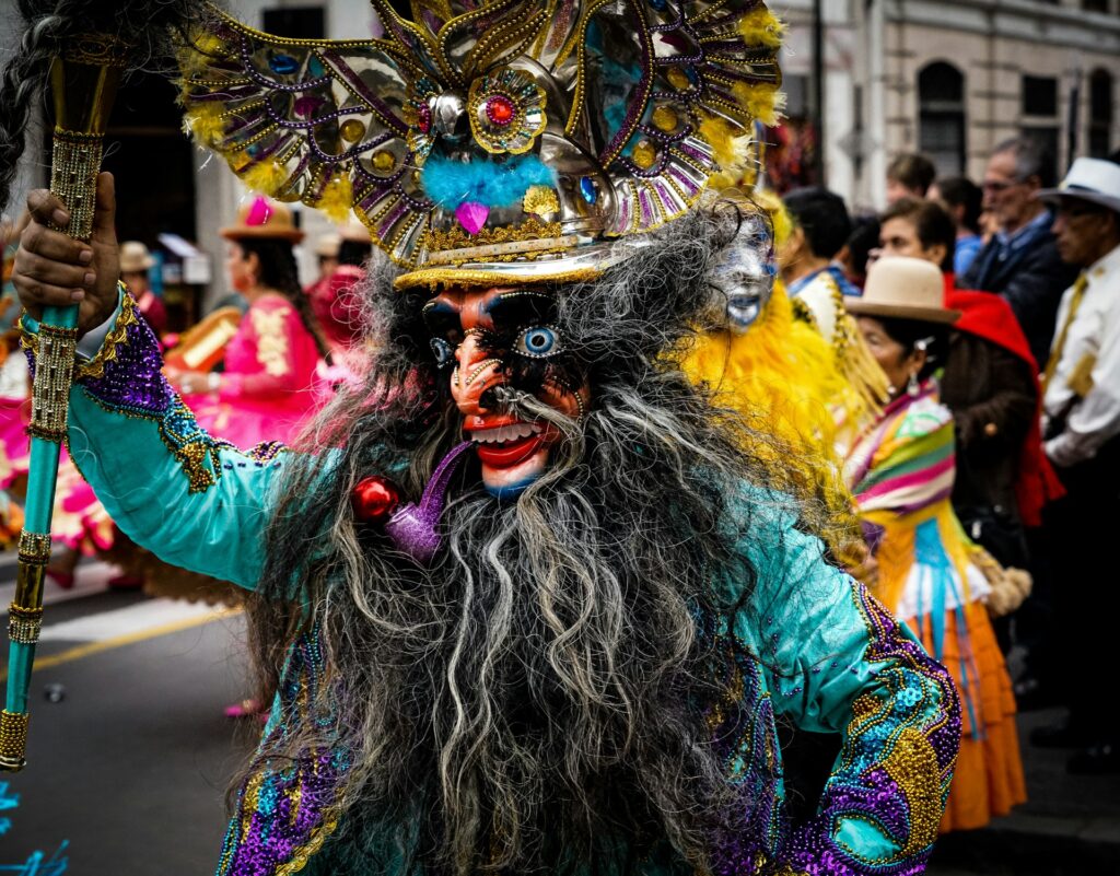 Image of a festival-goer in a traditional mask and costume