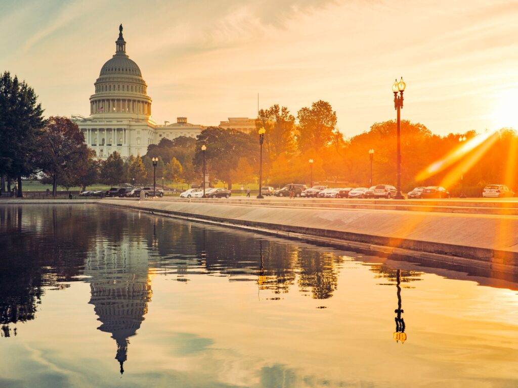 Capitol hill in the morning sunlight, with water in the foreground