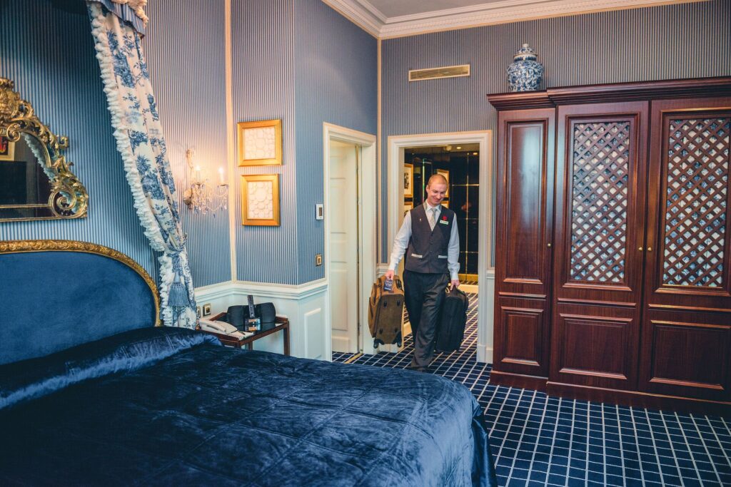 porter with luggage in hotel room