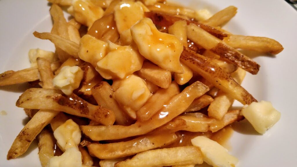 Chips covered with gravy and cheese curds make up the Canadian food poutine