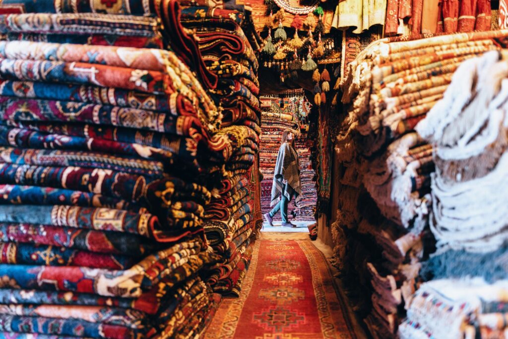 woman browsing carpet market in turkey