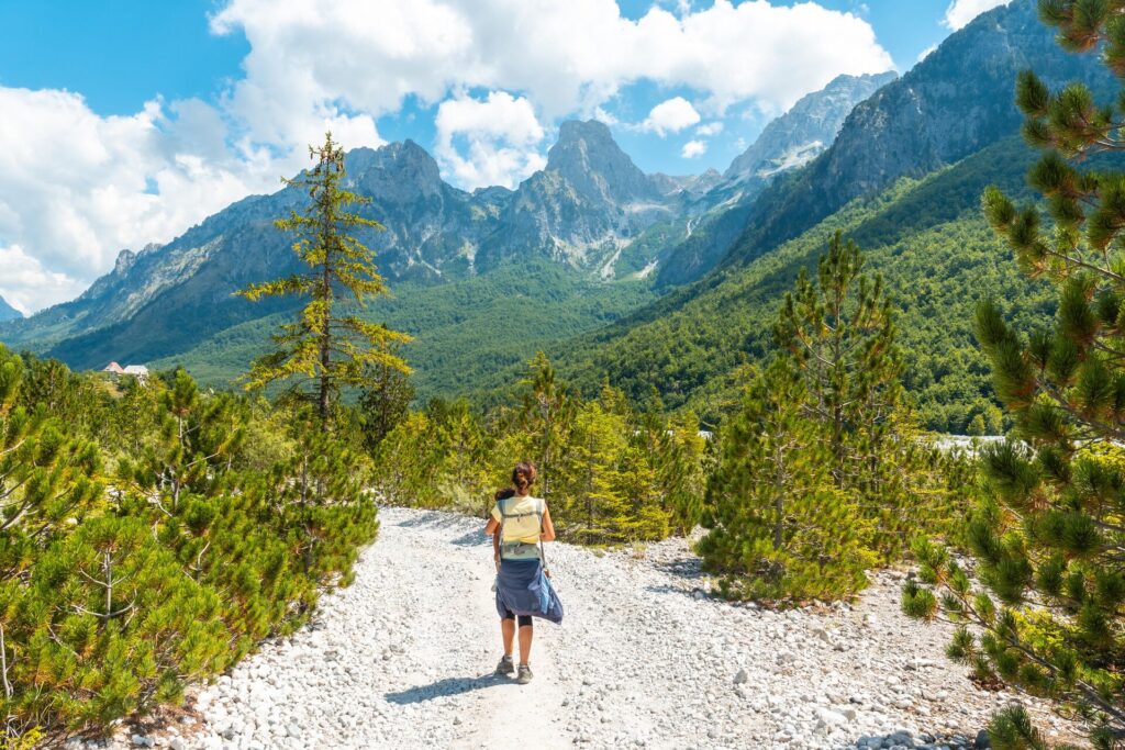 woman walking through valley in albania