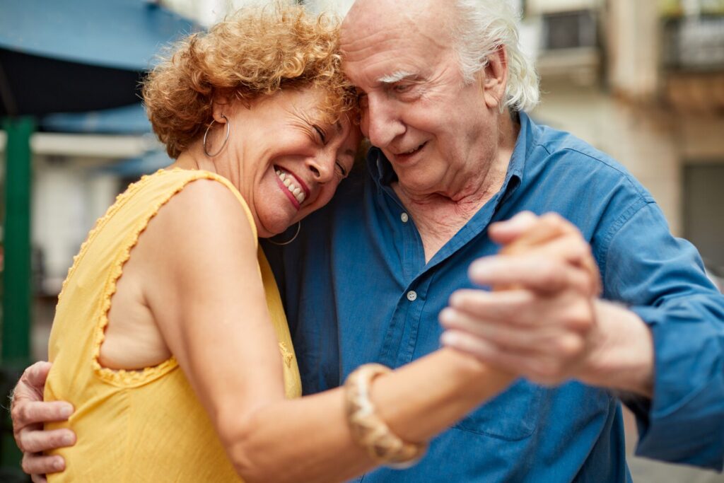 Elderly couple dancing Tango in Argentina, smiling and leaning into each other