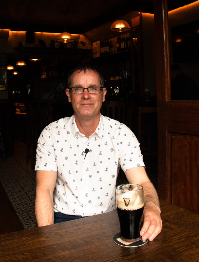 Photo of Local Expert Gary holding a pint of Guinness in a pub