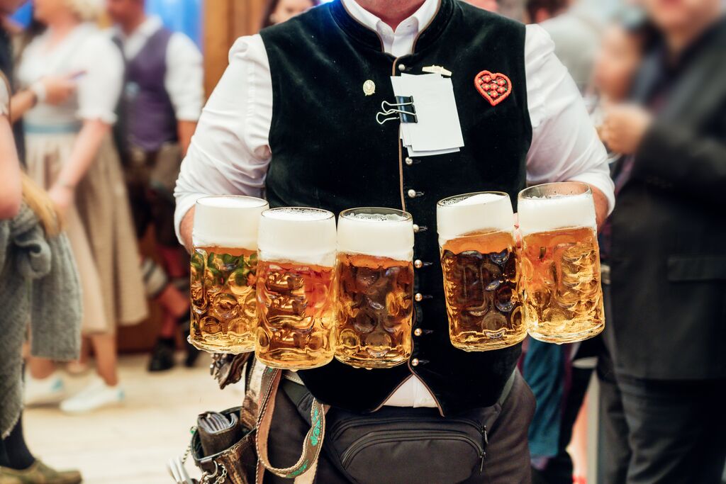 waiter carrying beer glasses at Oktoberfest