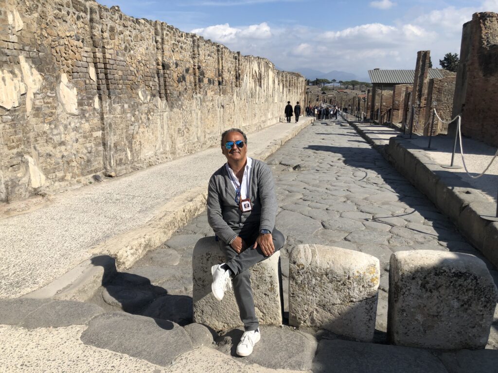 Vincenzo sitting on stone in Pompeii