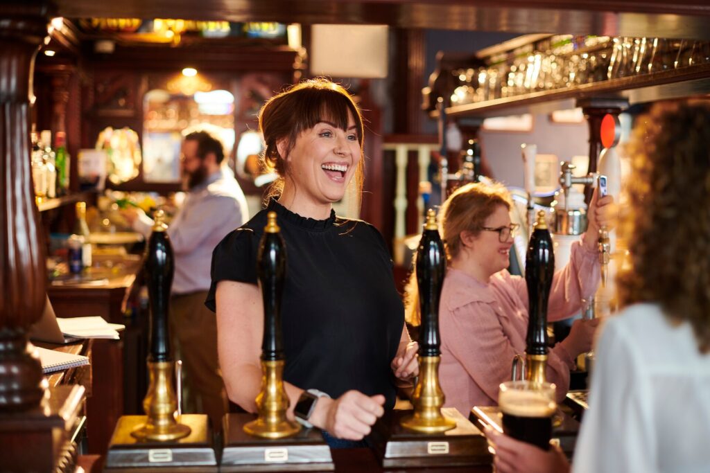 Girls smiling and laughing at a pub