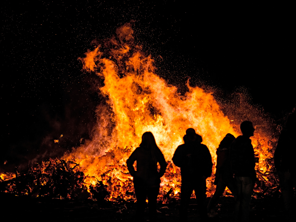 people standing in front of bonfire