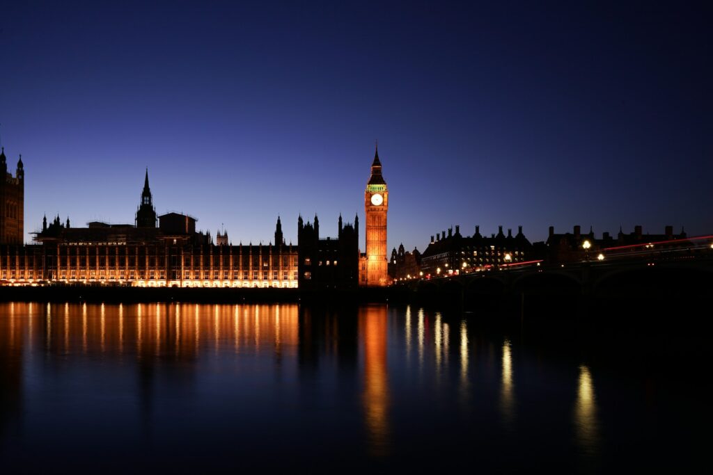 the UK's Houses of Parliament and Big Ben lit up at night seen from across the Thames