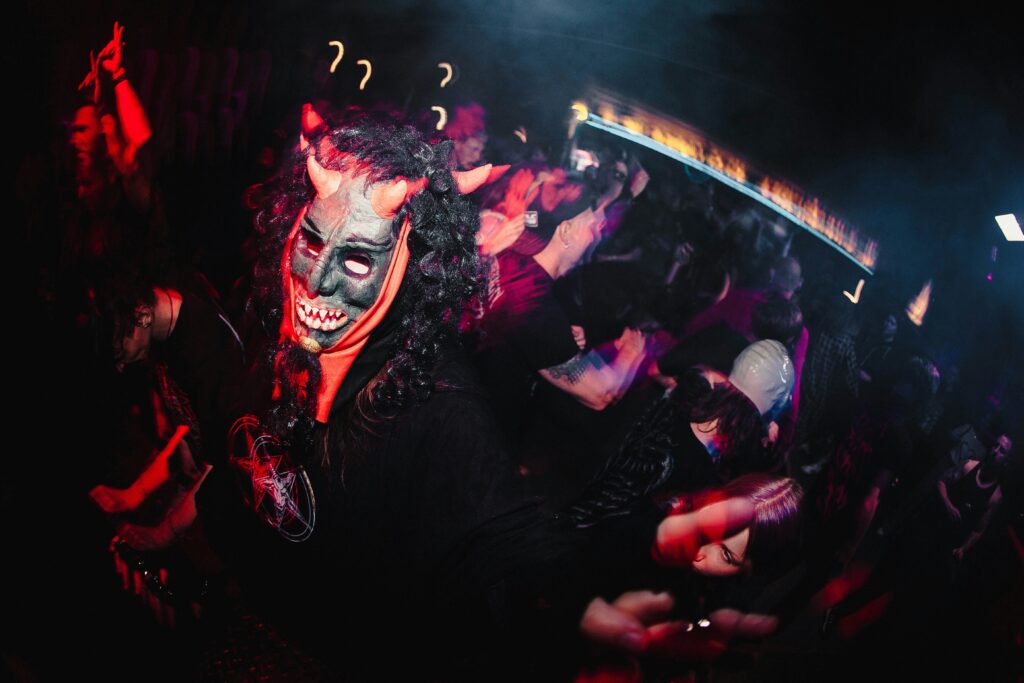 A person is dressed up as a horned figure in black and red at a Krampus parade in Austria