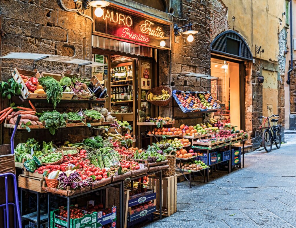 A colorful array of fruit and vegetables on display in a market in Florence, Italy