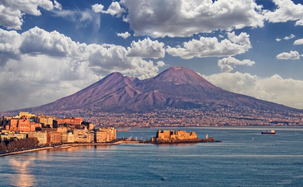 Volcano in background behind a city and coastline