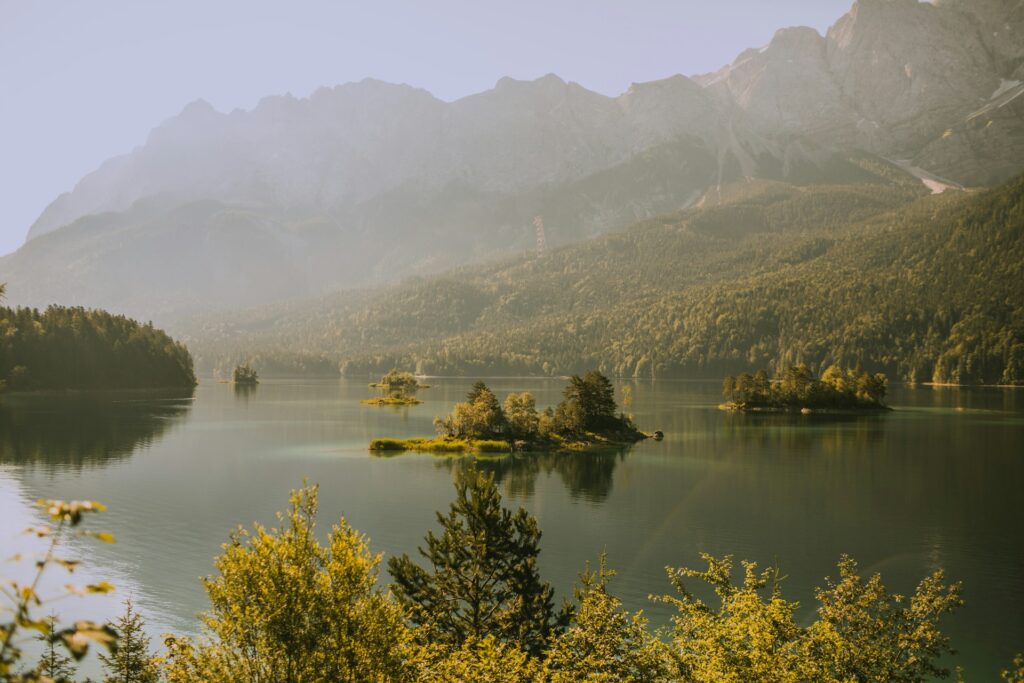 Small wooded islands on a lake surrounded by green hills