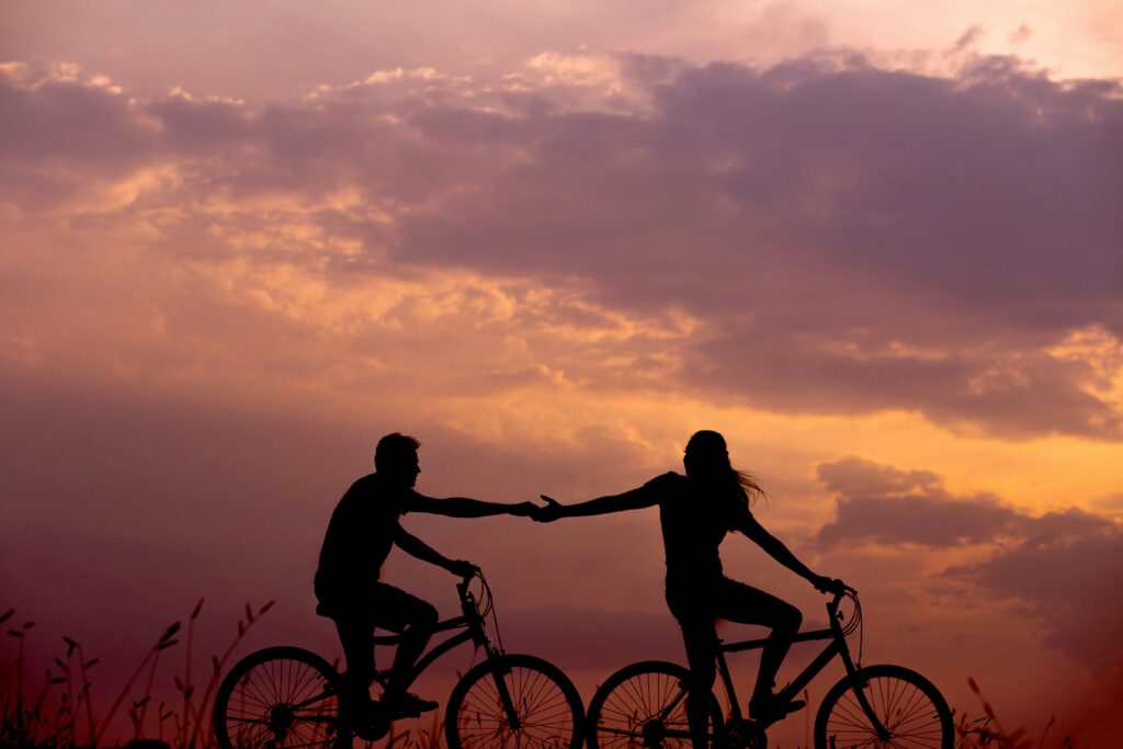 couple riding bikes in the sunset