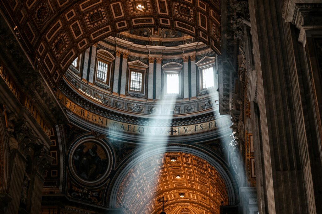 Rays of sunlight entering a high window in the dome of a cathedral