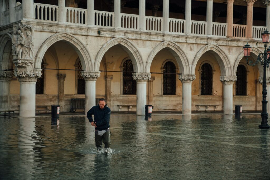 Man sweeping flood waters in Venice