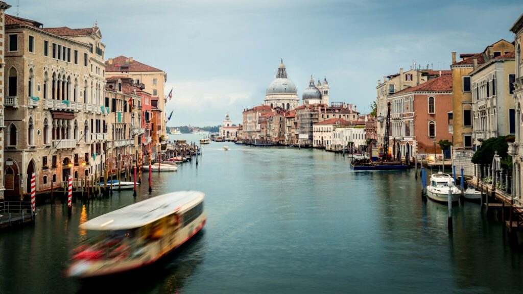 a view down the Grand Canal in Venice, with a large boat in the foreground 