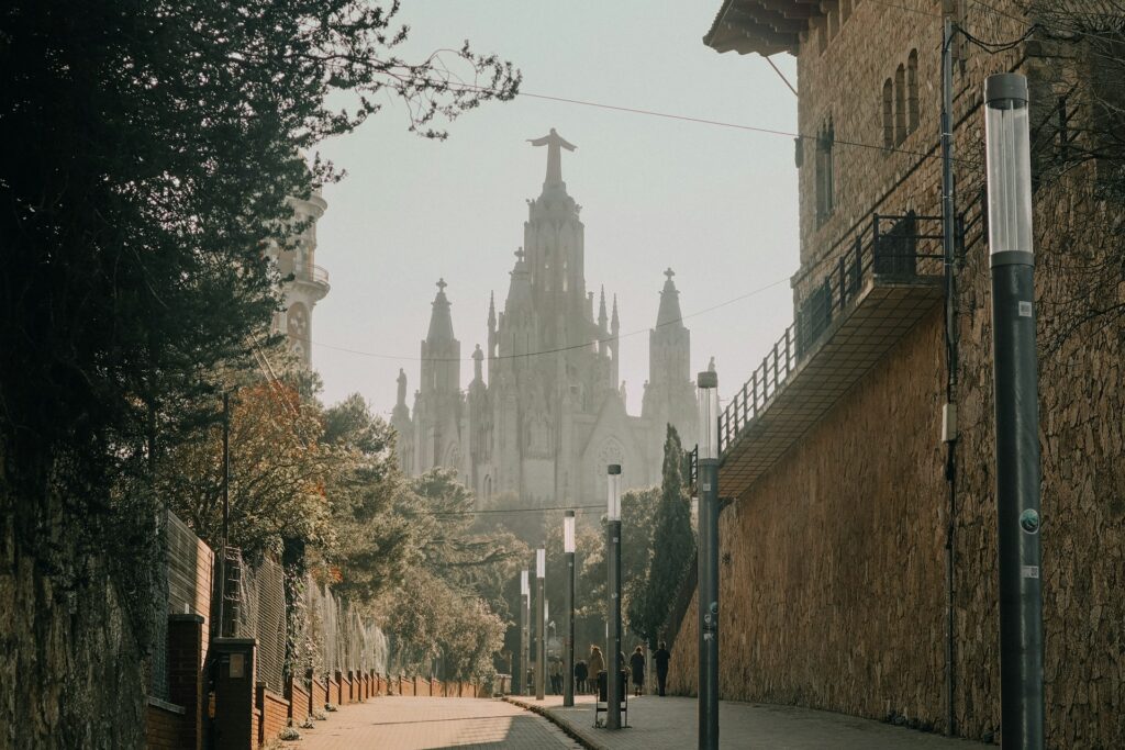 view of the Sagrada Familia looking down a street in Barcelona